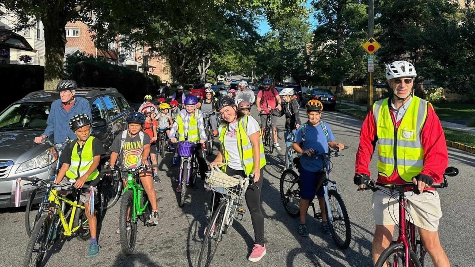 From a few to over 350, children and parents ride together to school as a ‘bike bus’