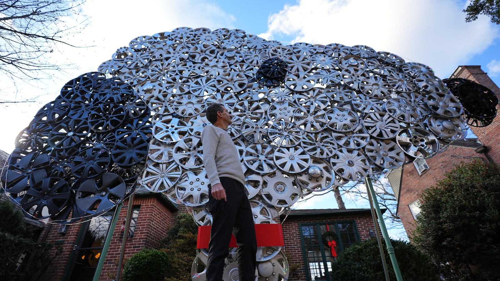 Baltimore cyclist finds joy in collecting lost hubcaps and stringing them into art