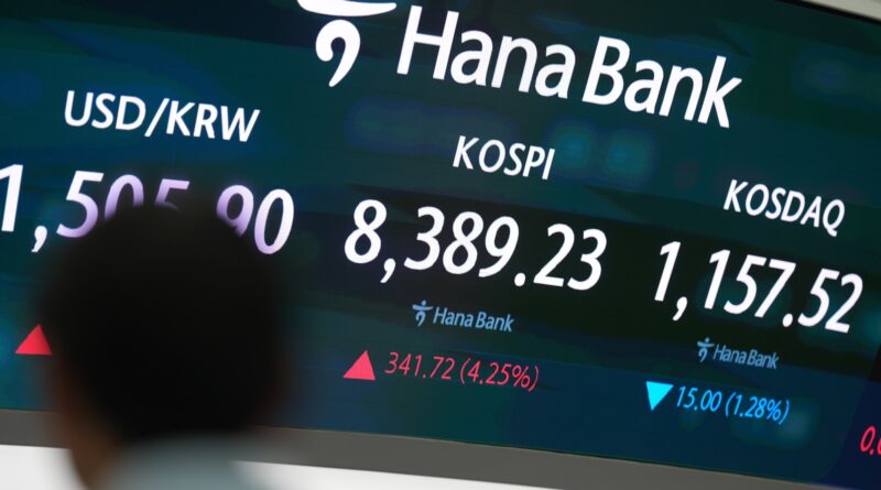 Asian shares are mostly higher, tracking Wall Street's fresh records, and oil prices fall