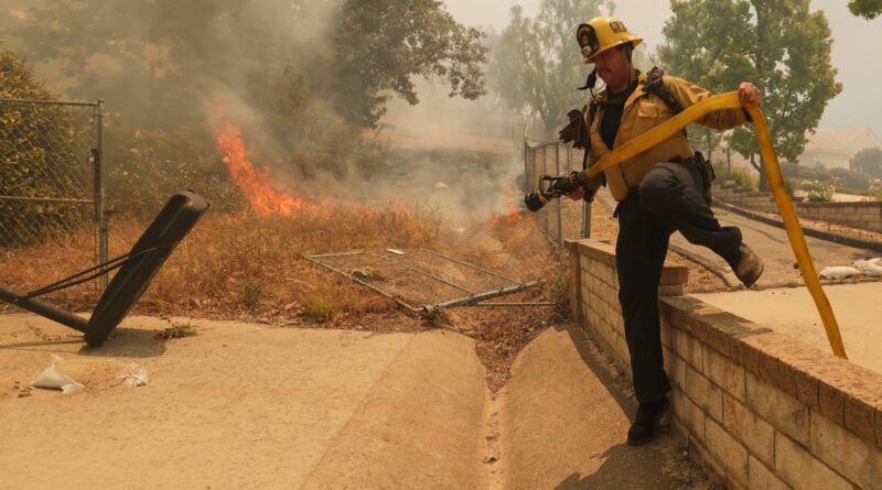 Fast-growing brush fire in Southern California threatens homes